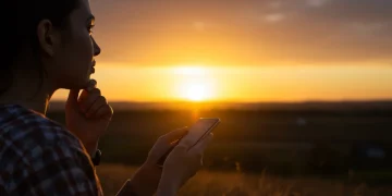 Person enjoying sunset, consciously reducing screen time